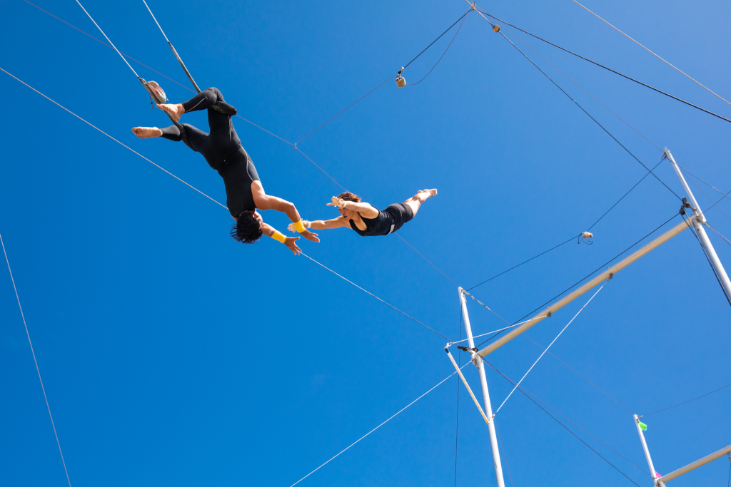 Acrobats flying through the sky